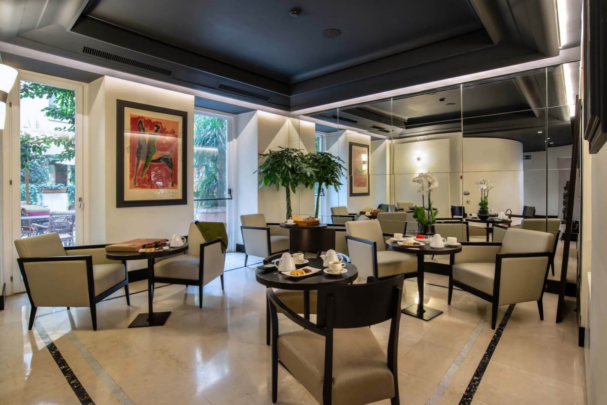 47 Boutique Hotel - The tea room with elegant furnishings and a mirrored wall.
