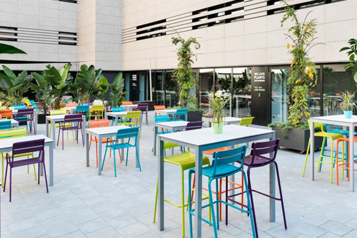 Andante Hotel - a group of tables and chairs outside of a building