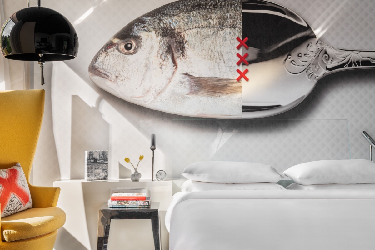 Andaz Amsterdam Prinsengracht - a bedroom with a bed and a fish mural