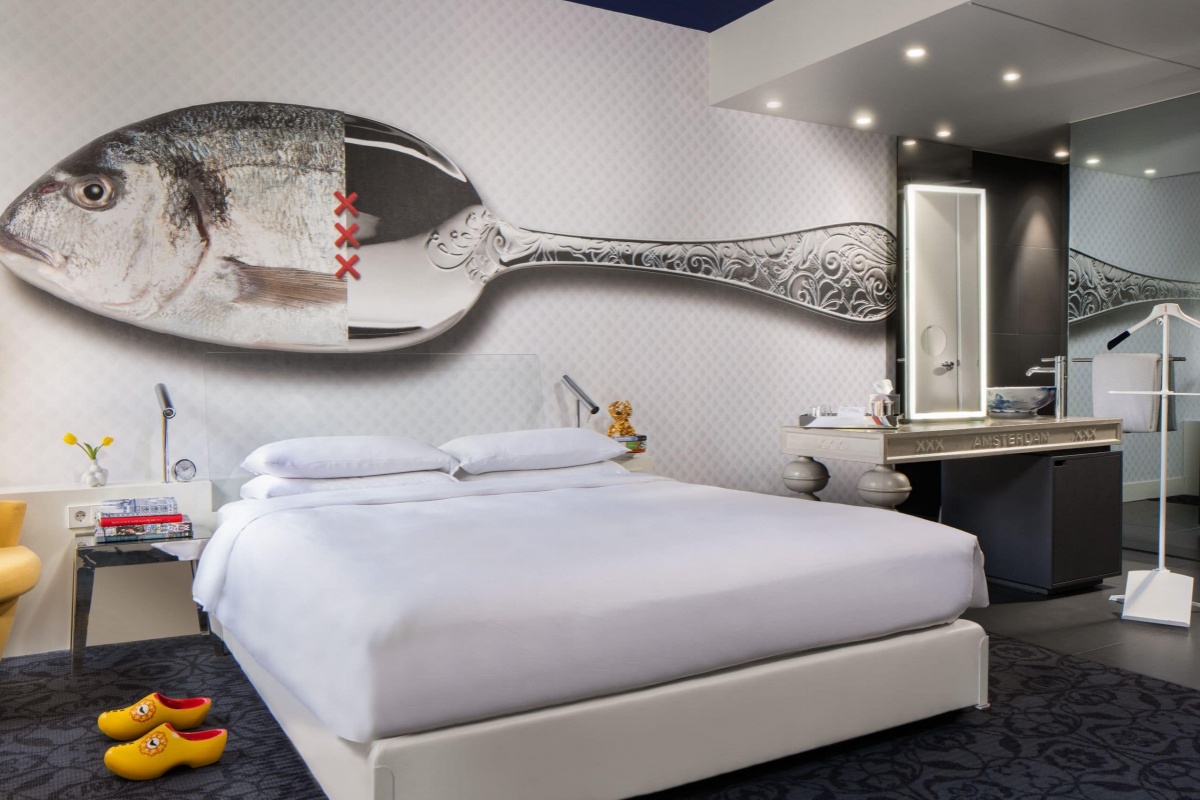 Andaz Amsterdam Prinsengracht - a bedroom with a large spoon on the wall