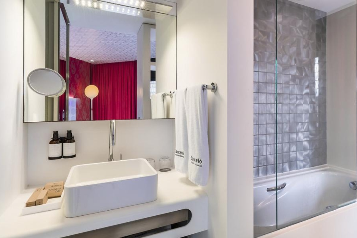 Barcelo Raval - a bathroom with a sink and a bathtub