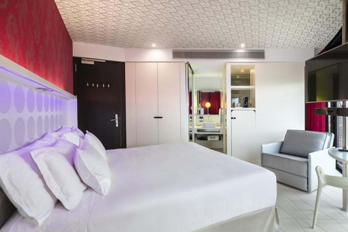 Barcelo Raval - a bed in a room