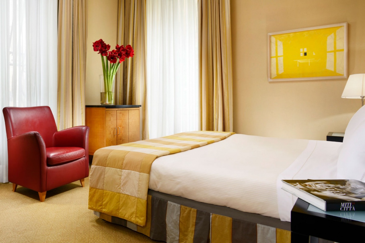Capo D'Africa Hotel  Colosseo - A comfortable double bedroom with contemporary furnishings.