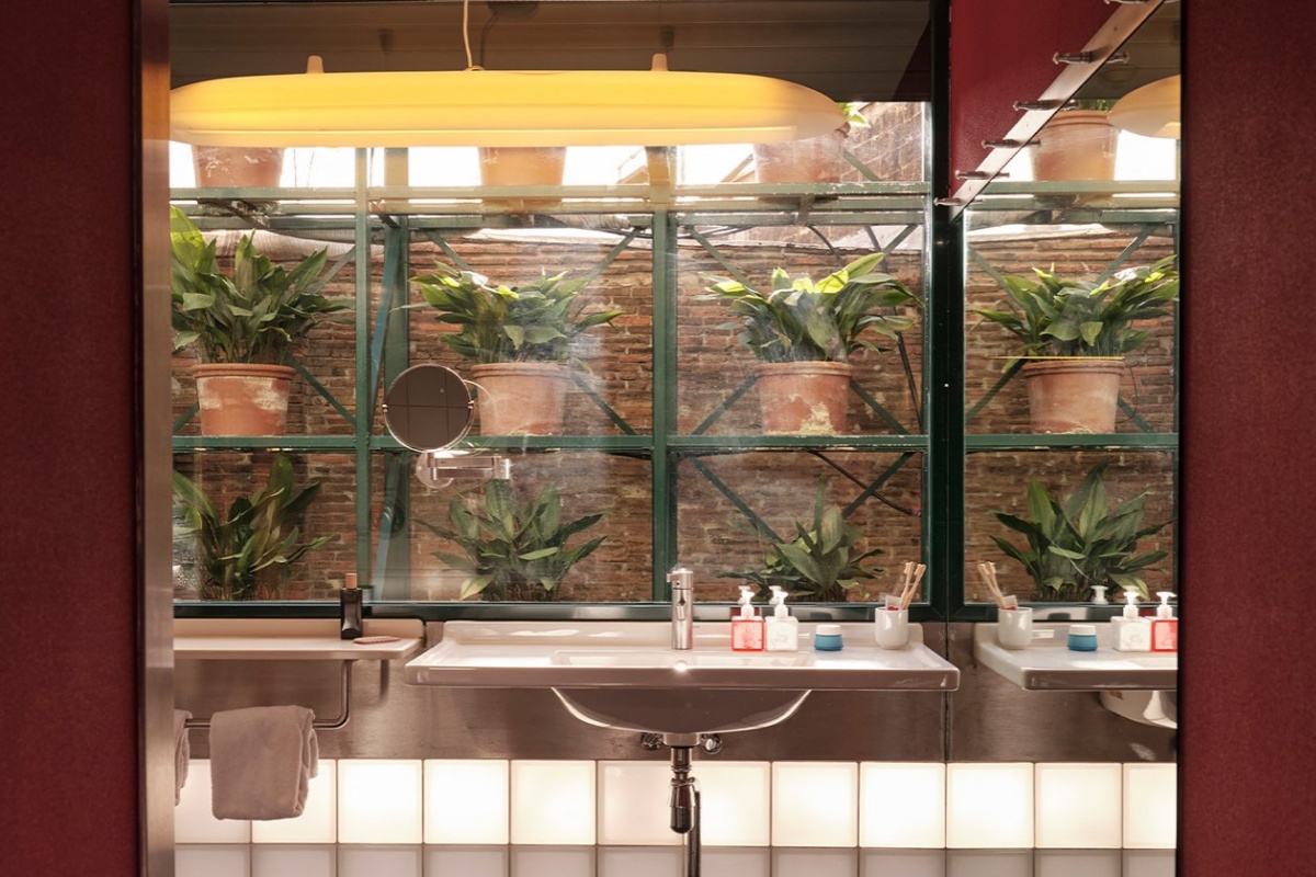 Casa Camper Hotel Barcelona - a bathroom with plants in pots