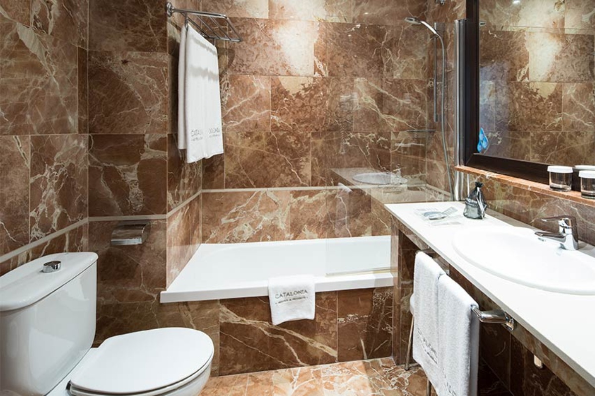 Catalonia Portal de l'Angel - a bathroom with marble tiles