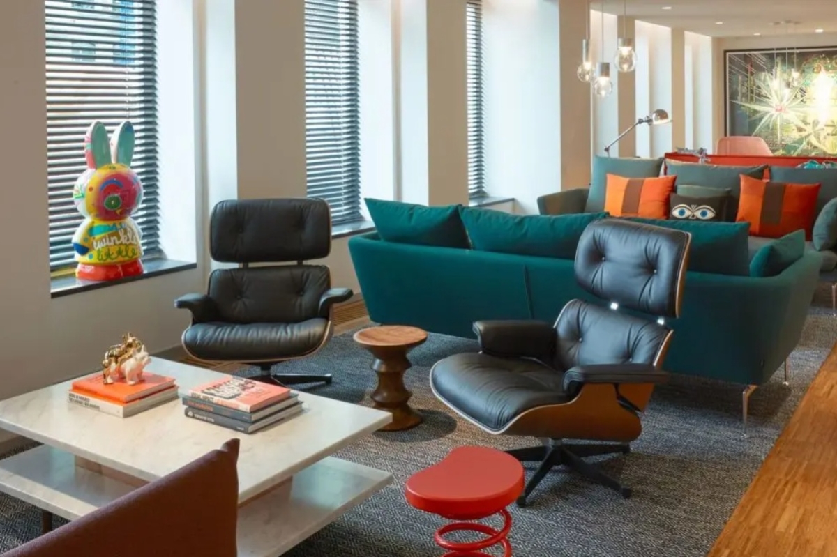 citizenM Amstel Amsterdam - a room with a couch and chairs