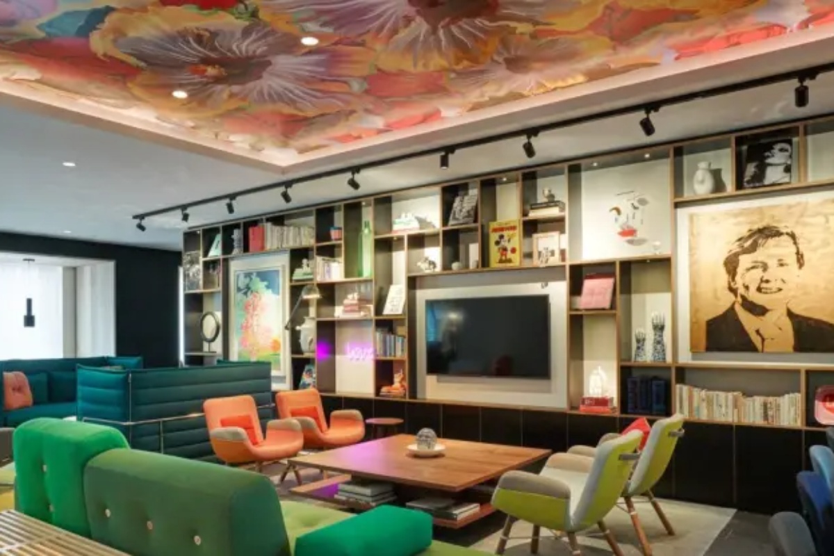 citizenM Amstel Amsterdam - a room with a tv and colorful chairs
