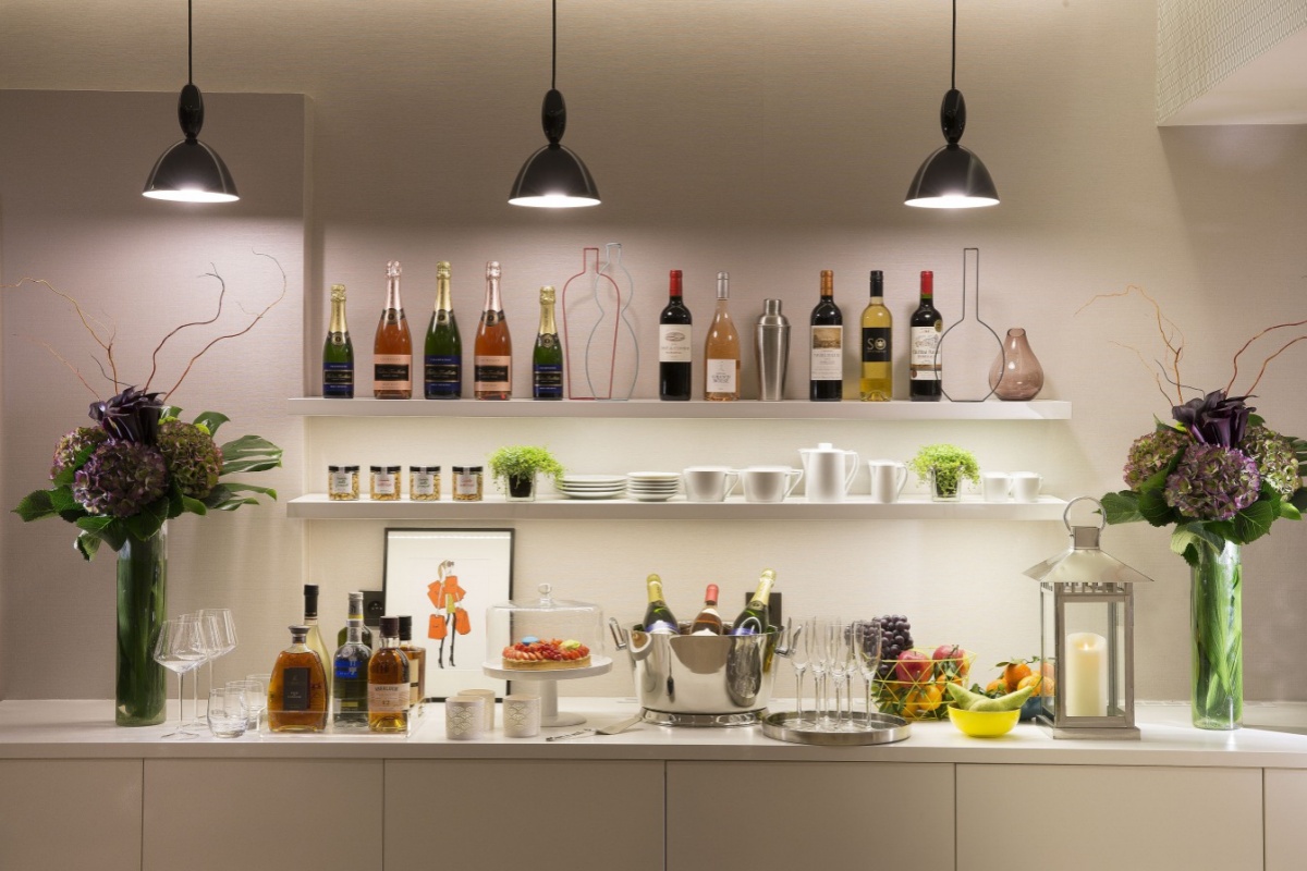 Cler Hotel - a bar with bottles of wine and glasses