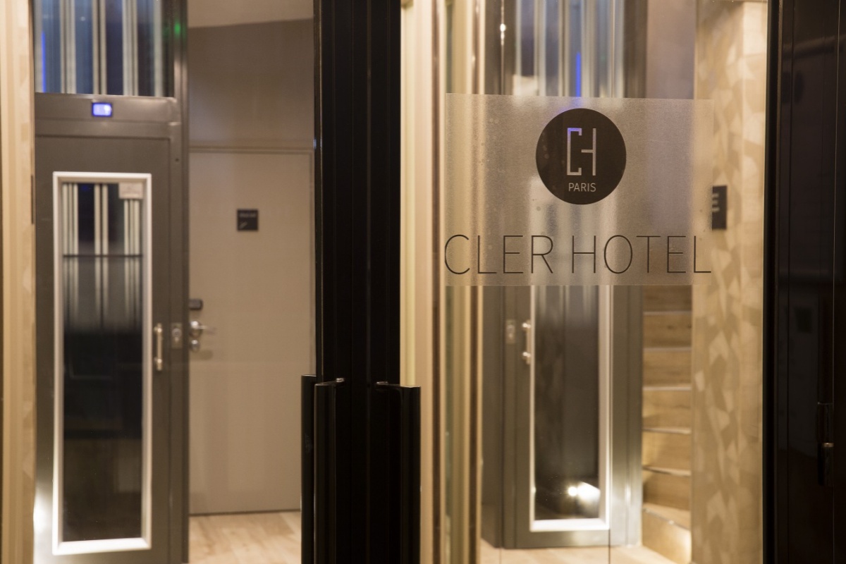 Cler Hotel - a glass door with a sign on it