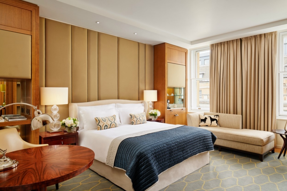 Corinthia Hotel - a bedroom with a bed and a couch