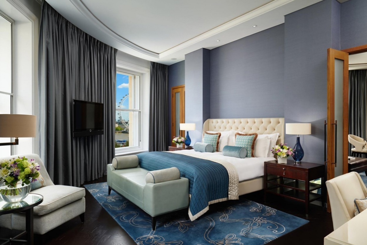 Corinthia Hotel - a bedroom with a bed and a tv
