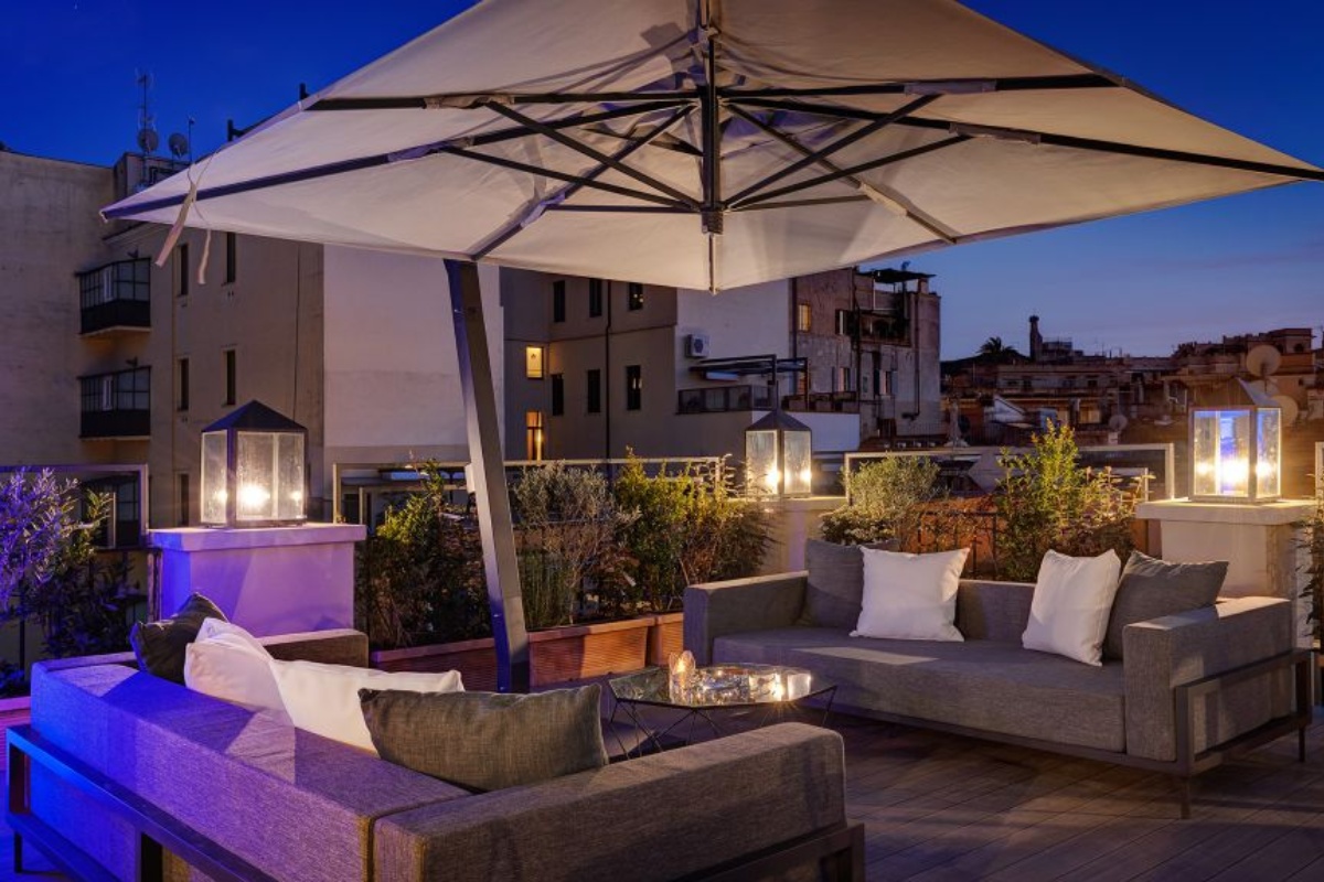 Dharma Boutique Hotel & Spa - The rooftop terrace lounge area at night.