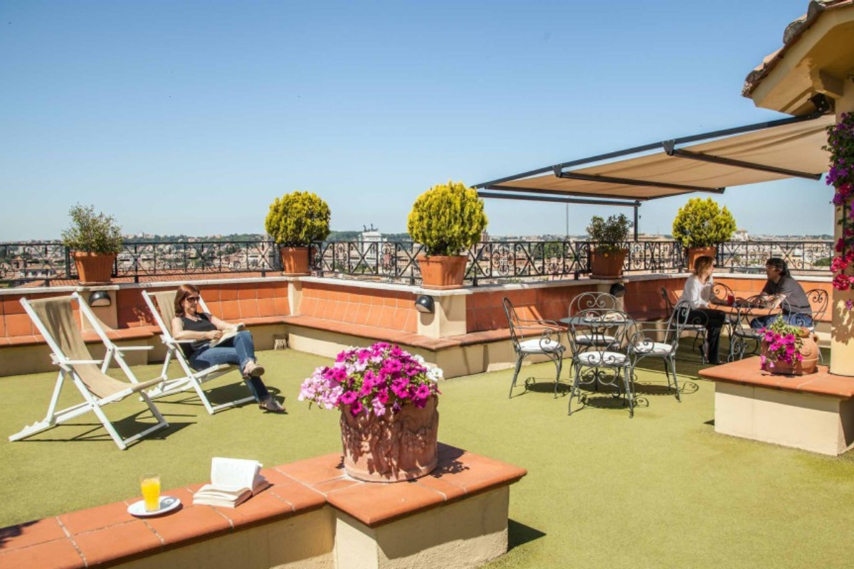 Hotel Colosseum - Rooftop terrace during the day, with panoramic views of Rome.