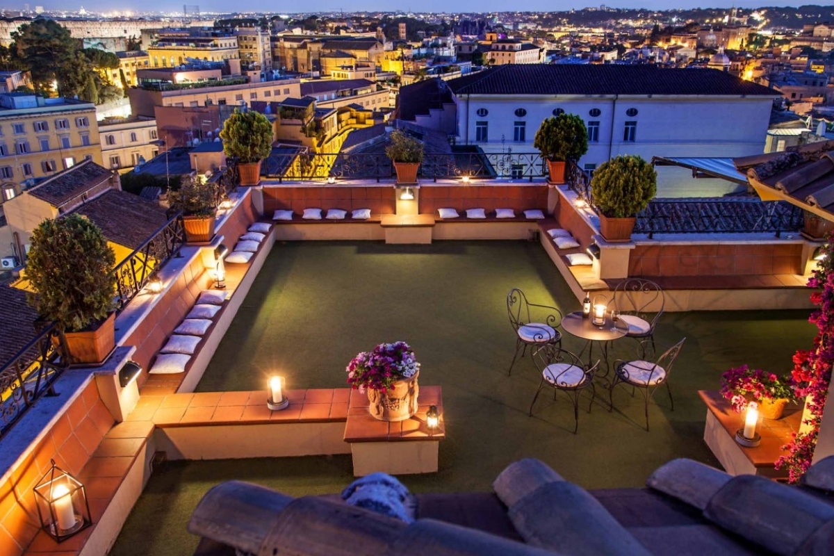 Hotel Colosseum - Rooftop terrace lounge at sunset.