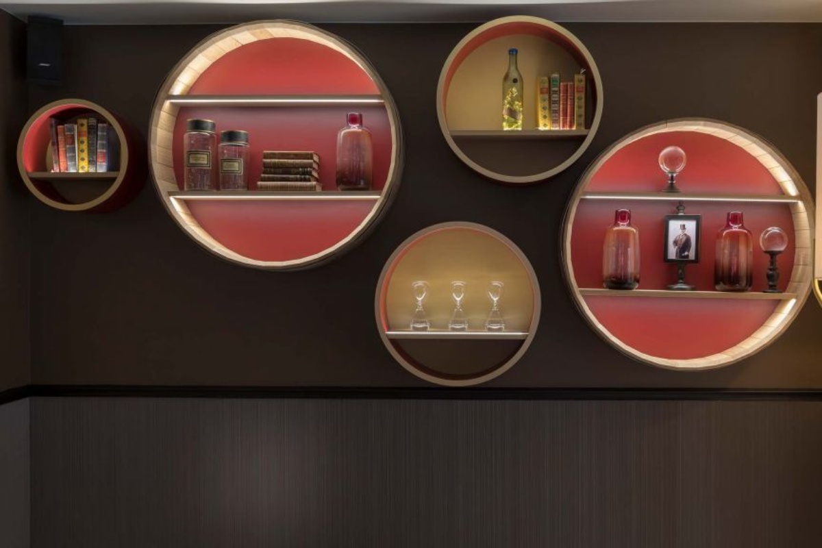 Hotel du Cadran - circular shelves with objects on the wall