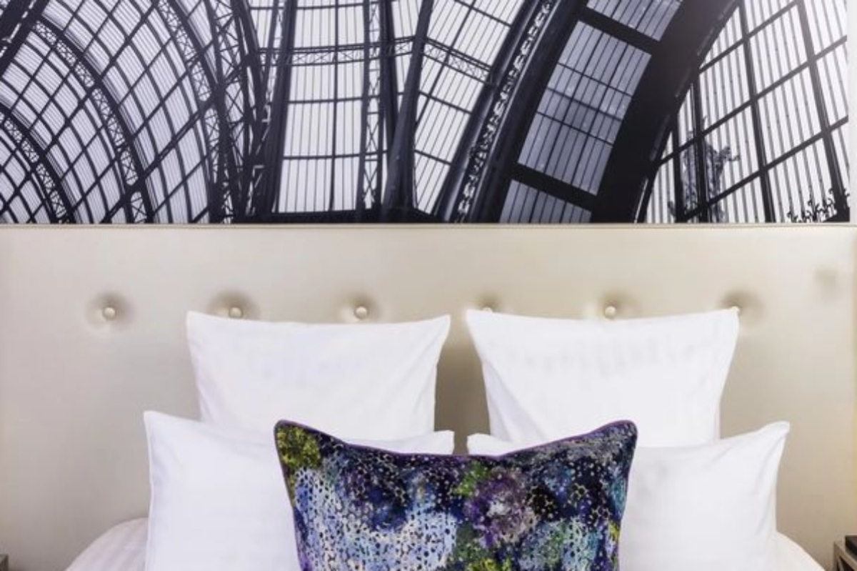 Hotel Gustave - a bed with pillows and a large dome