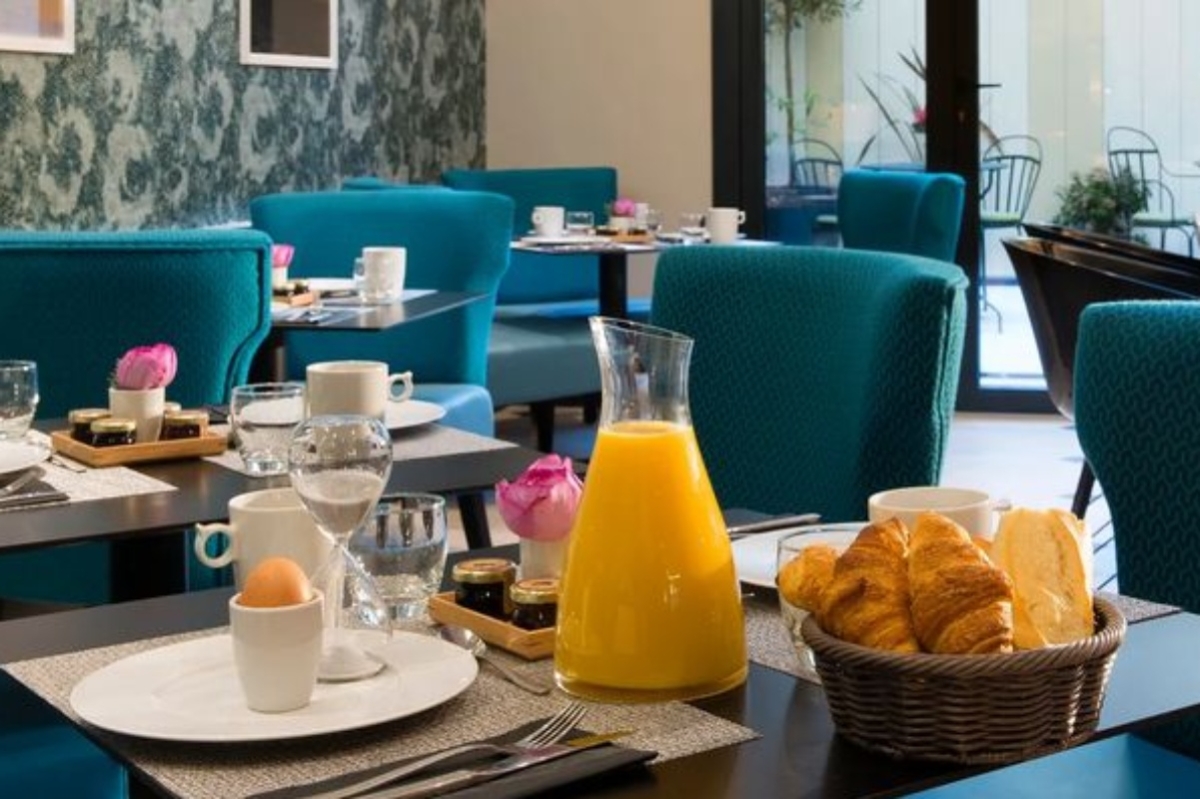Hotel Gustave - a breakfast table with croissants and orange juice
