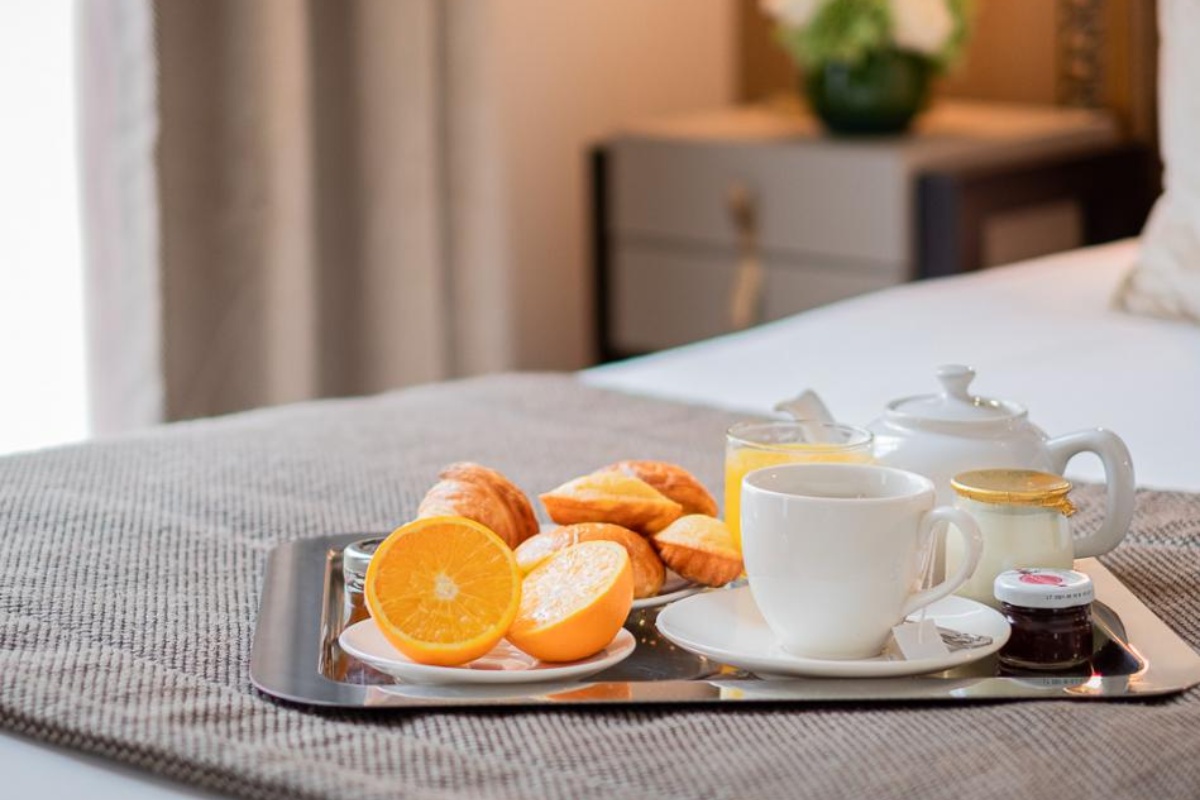 Hotel Le Walt - a tray of breakfast items on a bed