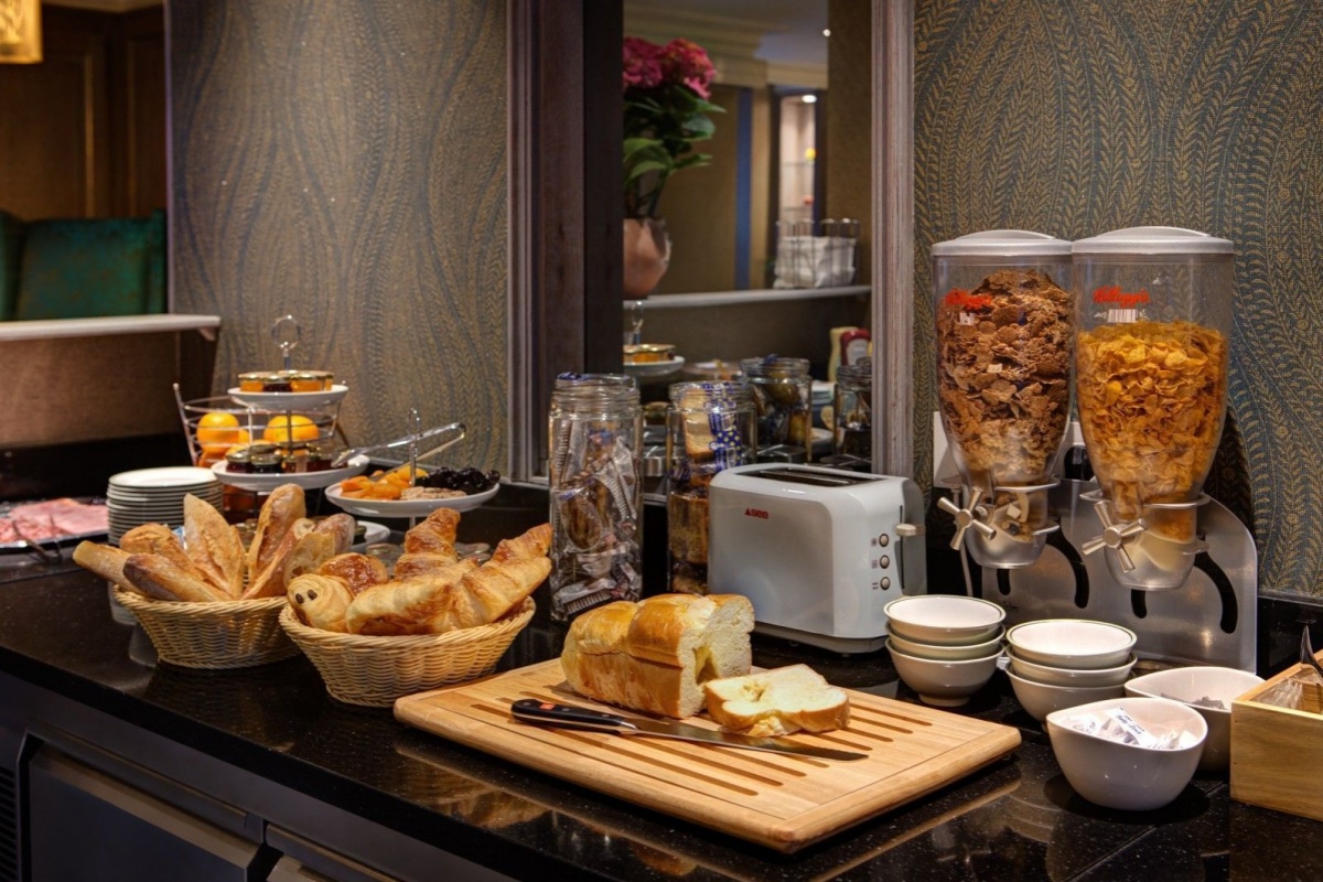 Hotel Muguet - a breakfast buffet with bread and food
