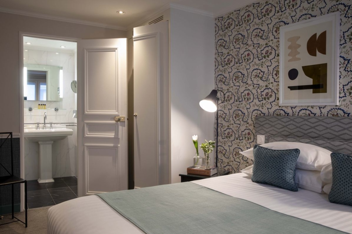 Hotel Relais Bosquet Paris by Malone - a bedroom with a bed and a sink
