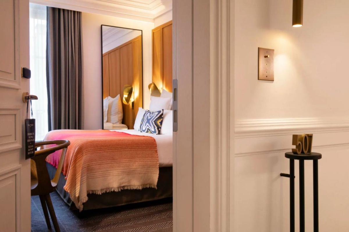 Hotel Vernet - a room with a bed and a mirror