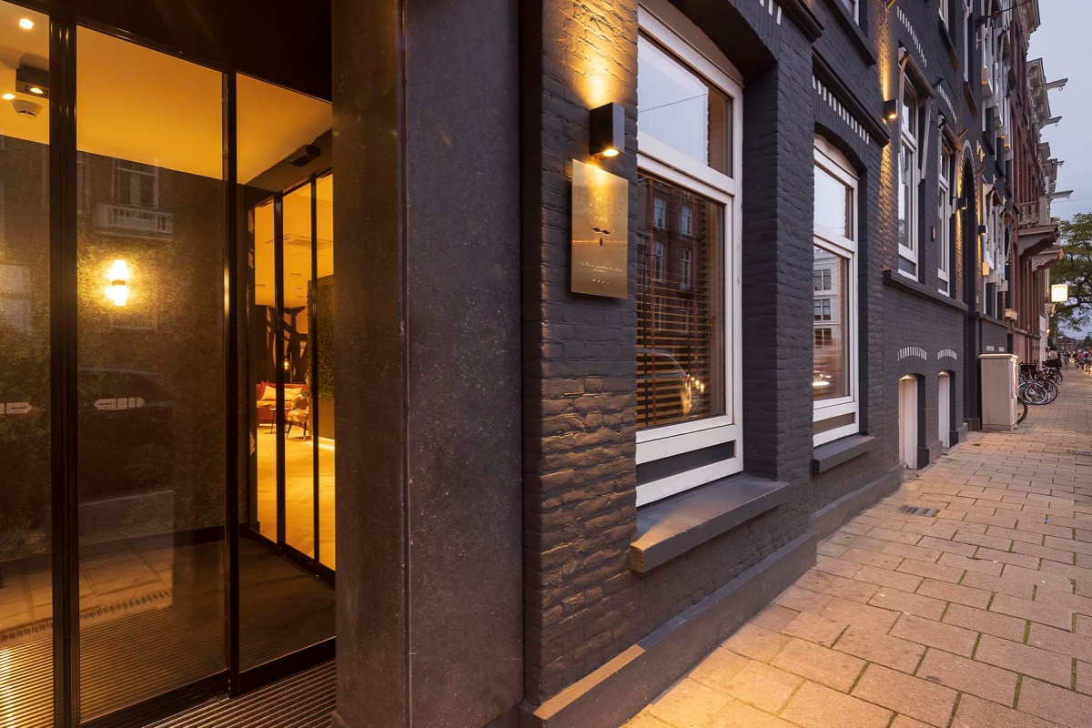 Huygens Place - a building with glass doors and a sidewalk