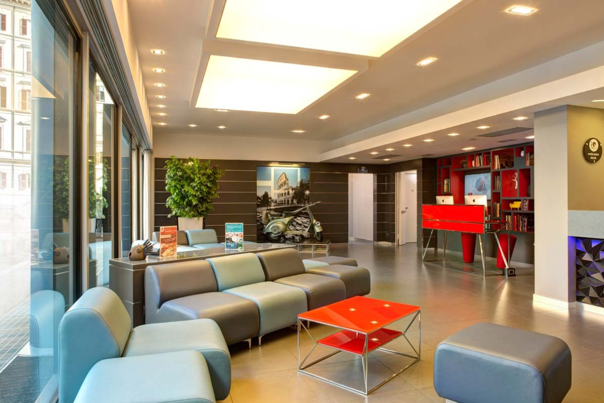 iQ Hotel Roma - Hotel reception with contemporary furnishings.