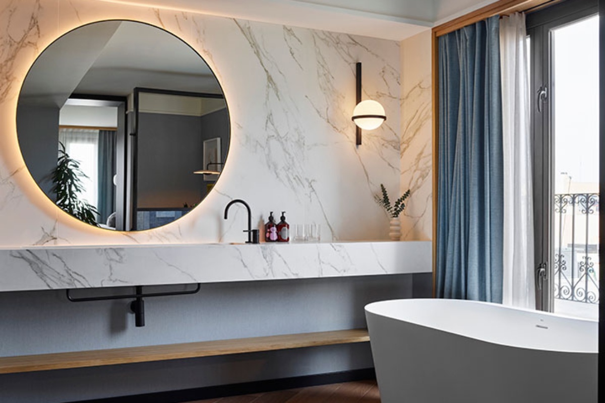 Kimpton Vividora Hotel - a bathroom with a tub and a mirror