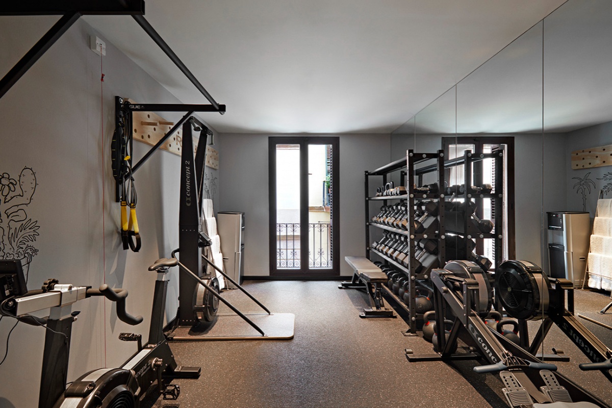 Kimpton Vividora Hotel - a room with exercise equipment and a mirror