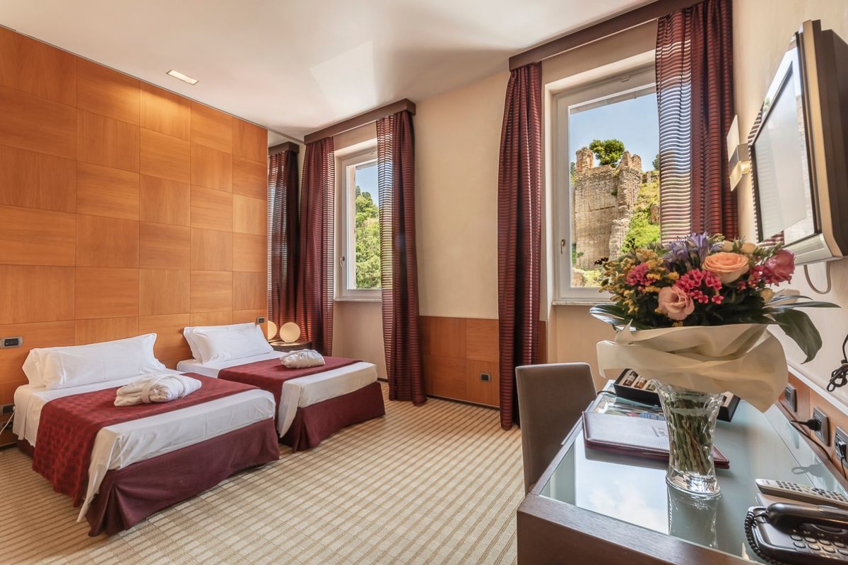 Kolbe Hotel Rome - A twin room with large windows overlooking the city of Rome.