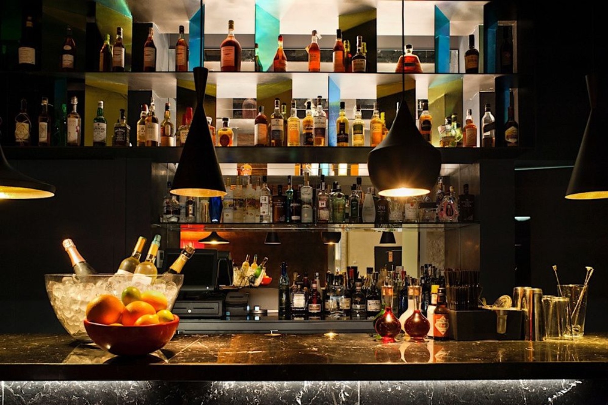 Mercer Hotel Barcelona - a bar with bottles of alcohol