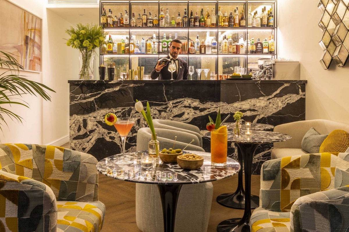 Nerva Boutique Hotel - A barman pouring drinks behind the bar.