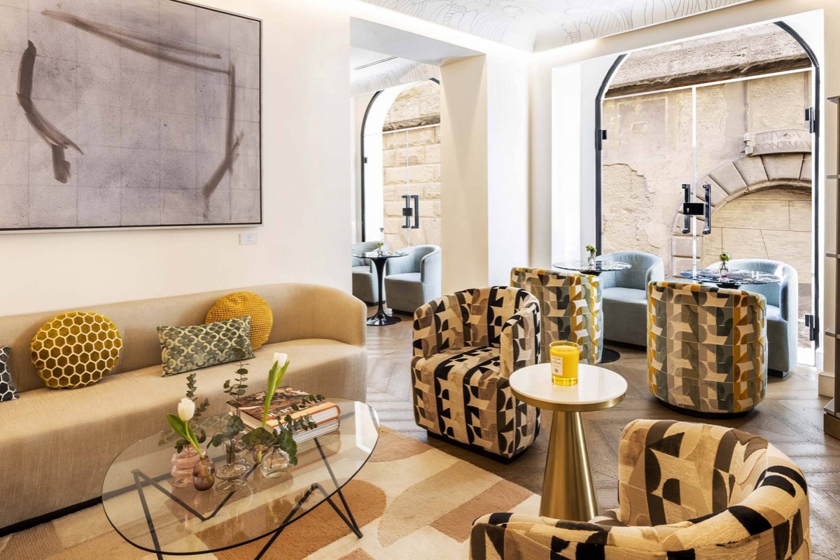 Nerva Boutique Hotel - Hotel lounge with contemporary furnishings and arched glass doors. 