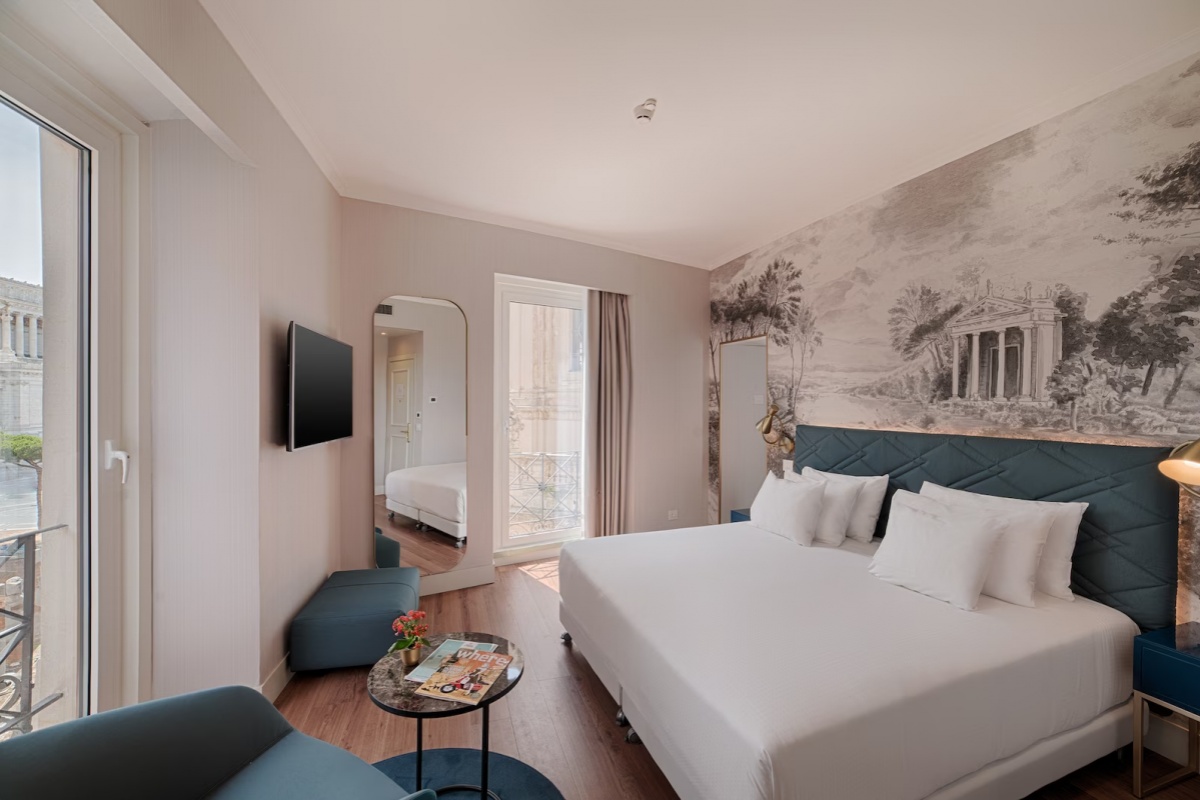 NH Collection Roma Fori Imperiali - A comfortable hotel room with contemporary furnishings.