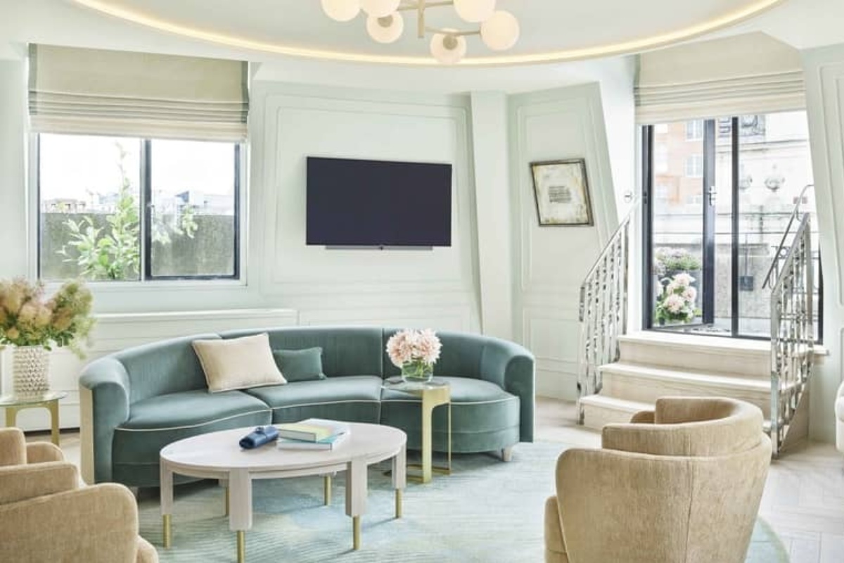 One Aldwych - a living room with a couch and a television