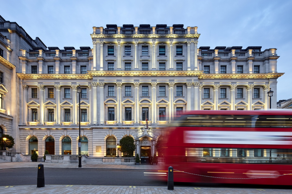 Sofitel London St James - a double decker bus in front of a large white building
