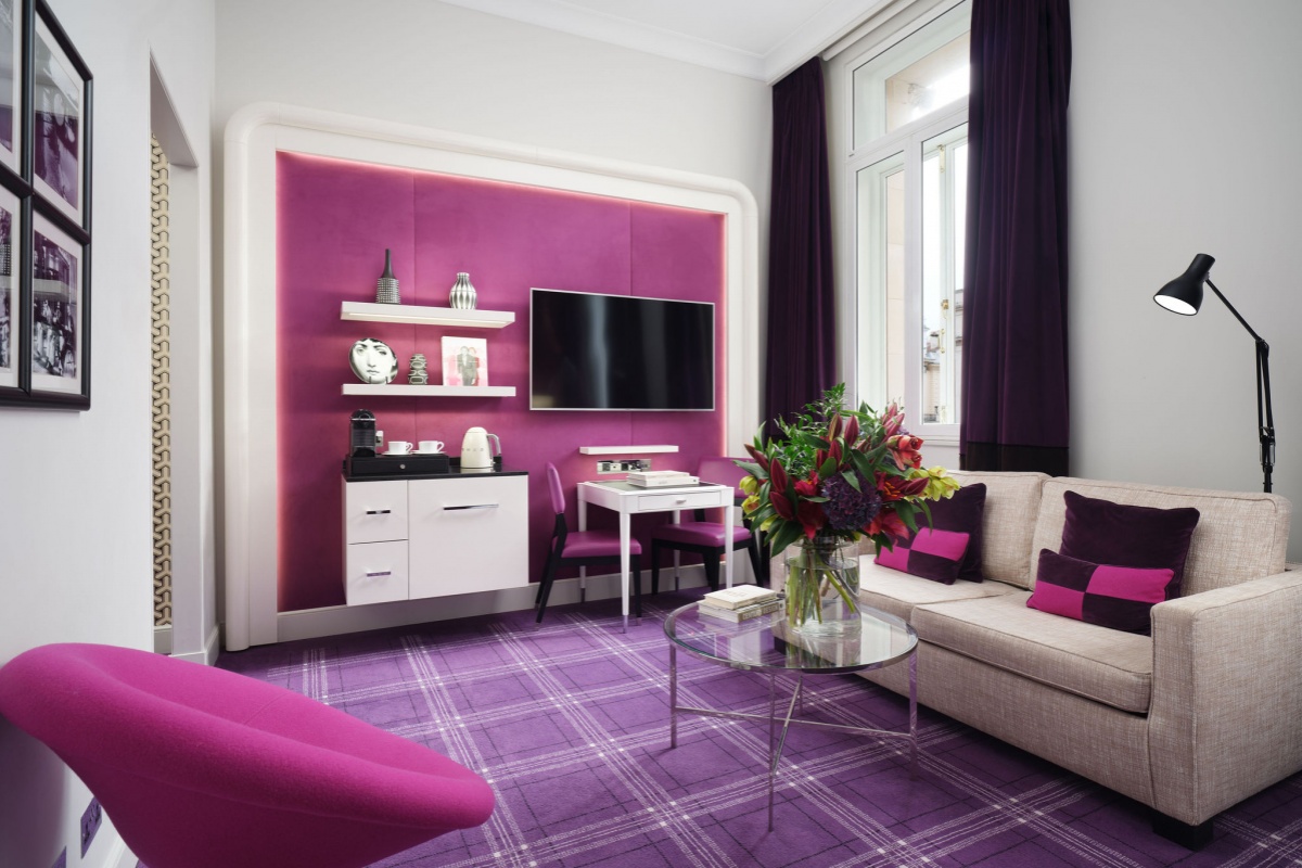 Sofitel London St James - a room with purple walls and a couch