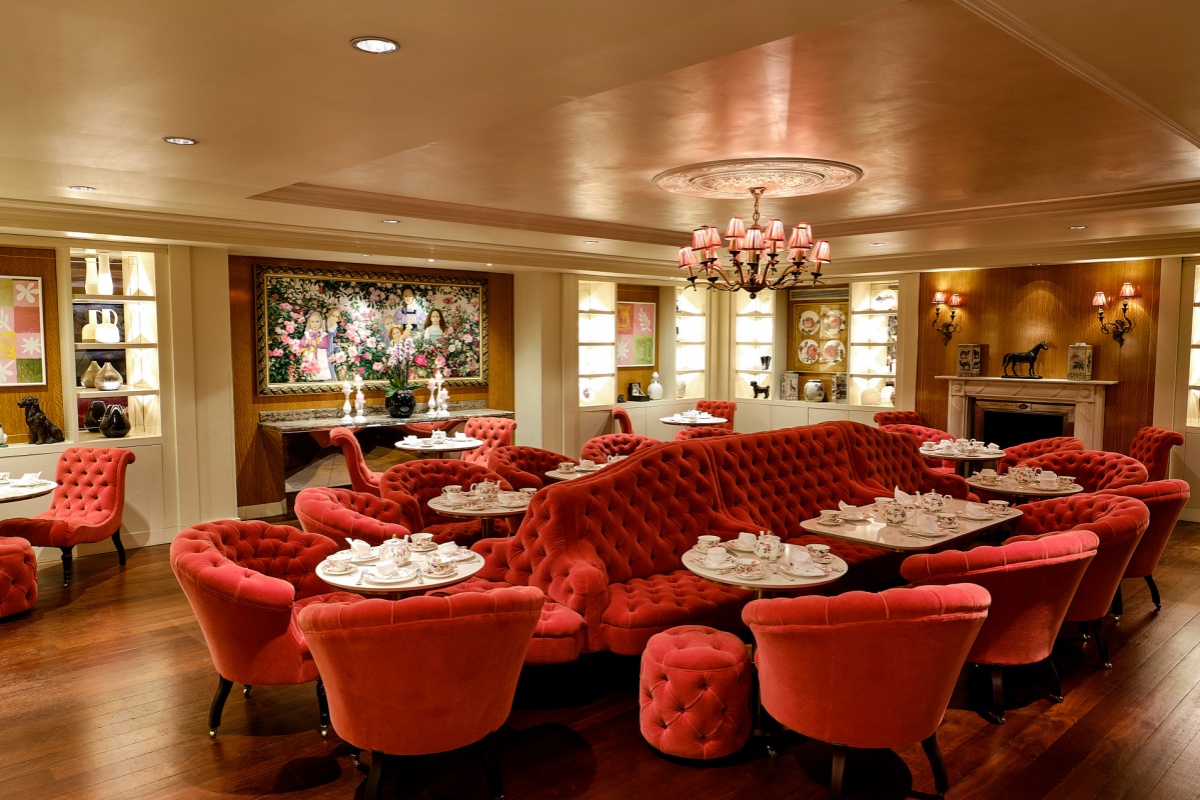 Sofitel London St James - a room with red couches and tables