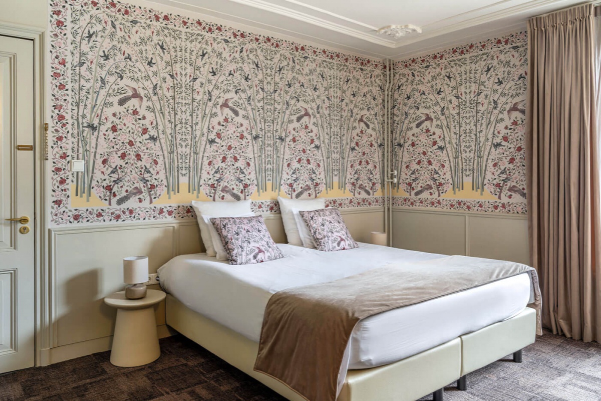 'T Hotel - a bed with a wallpaper on the wall