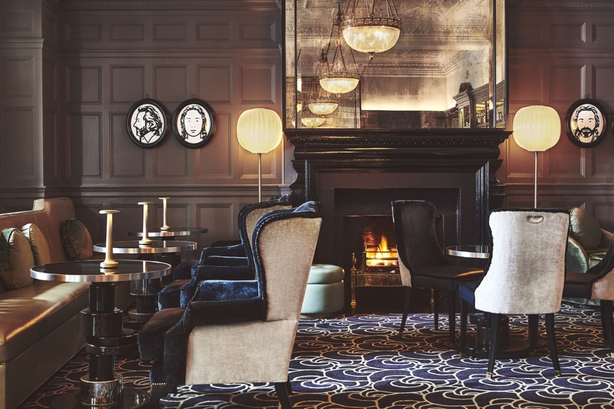 The Connaught - a room with a fireplace and chairs