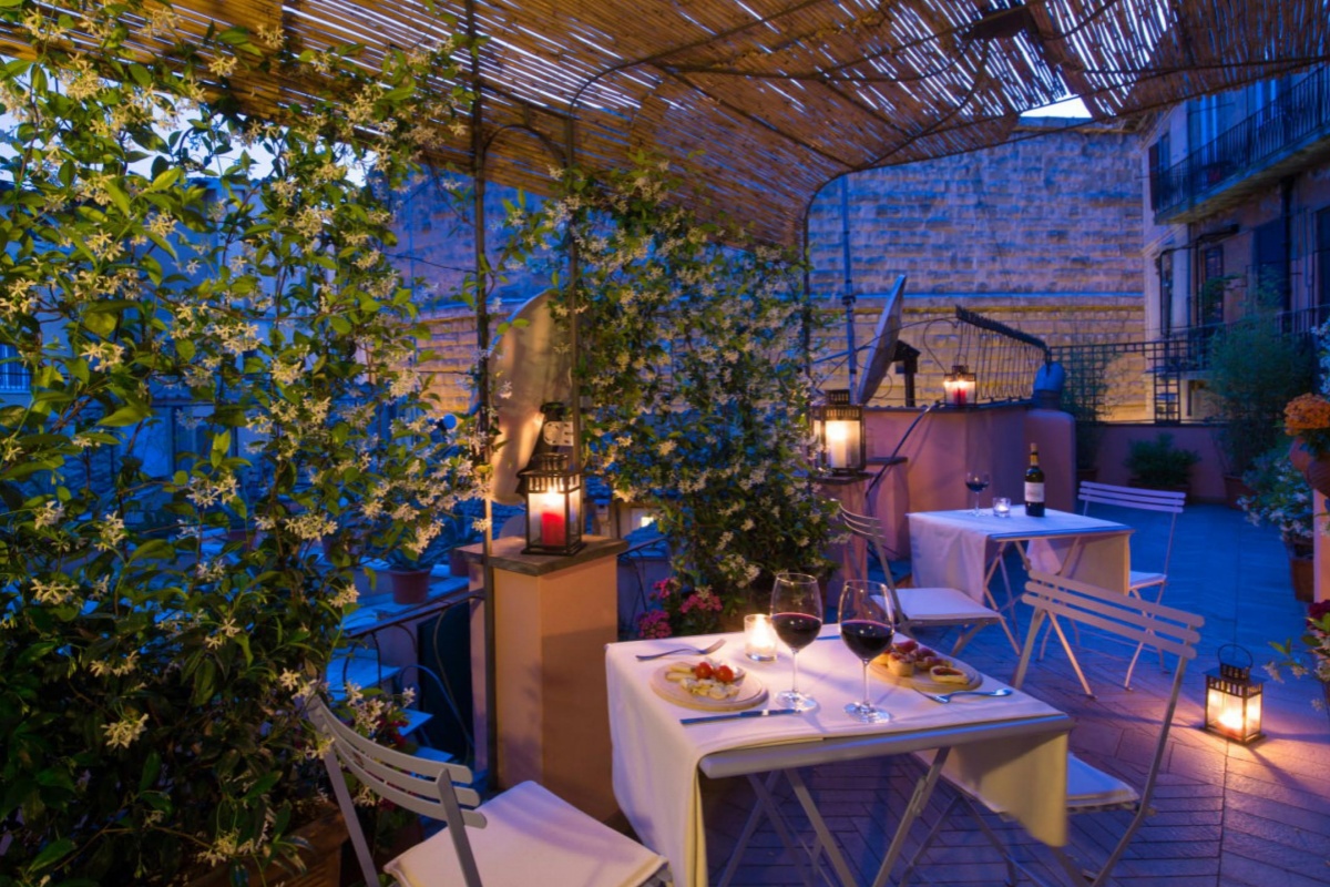 The Inn At The Roman Forum - Private terrace dining at night.
