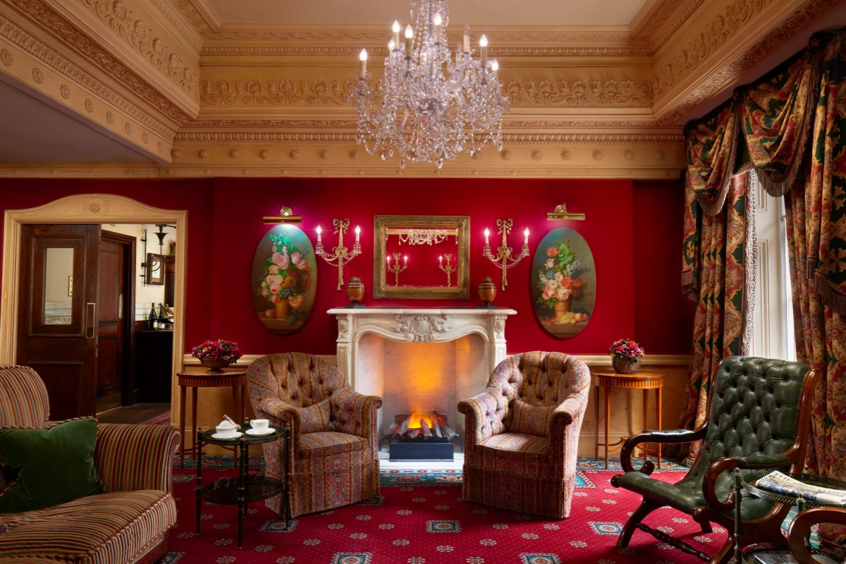 The Montague on The Gardens - a room with a fireplace and chairs