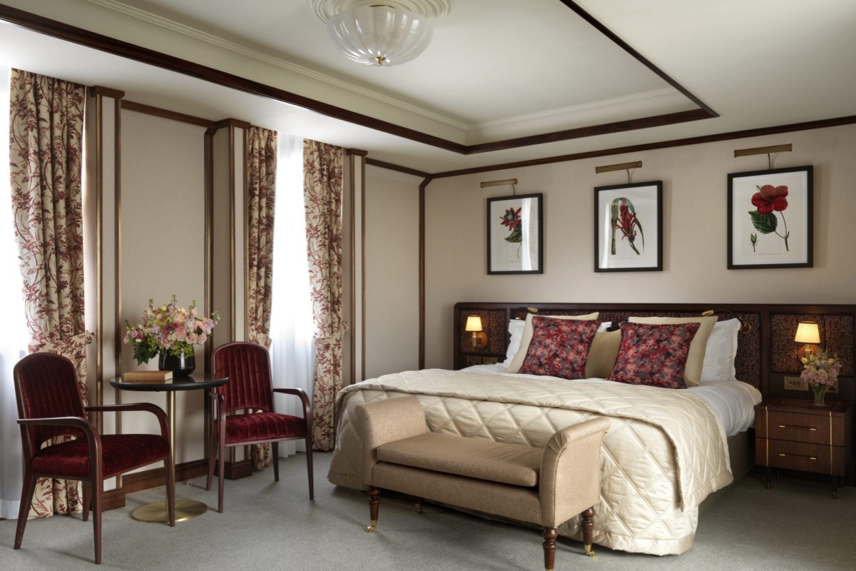 The Stafford London - a bedroom with a bed and chair