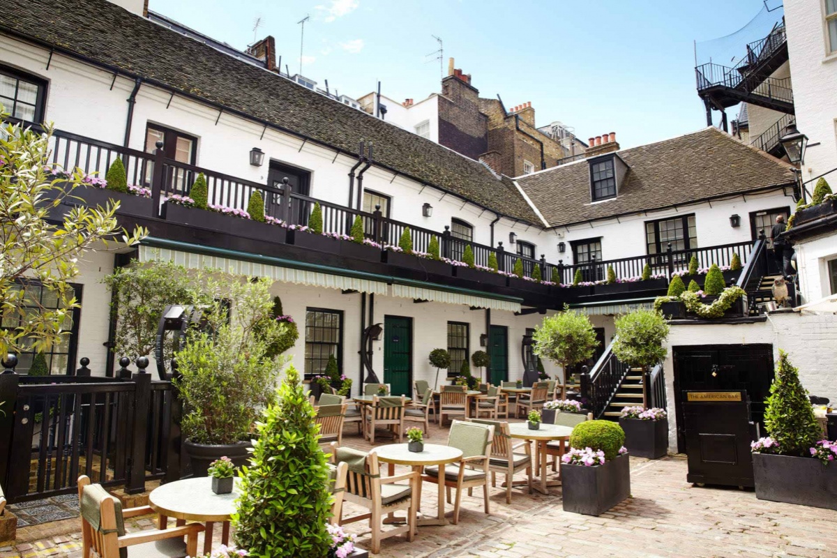 The Stafford London - a courtyard with tables and chairs