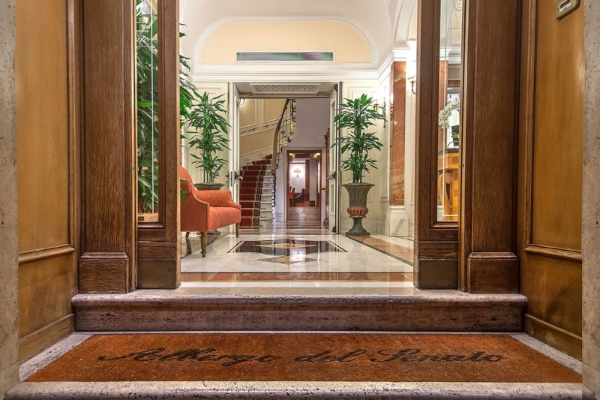 Albergo del Senato - a doorway with glass doors and a staircase