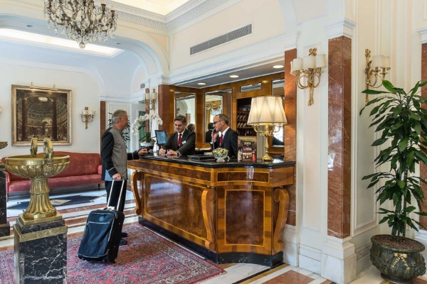 Albergo del Senato - a group of men standing at a reception desk