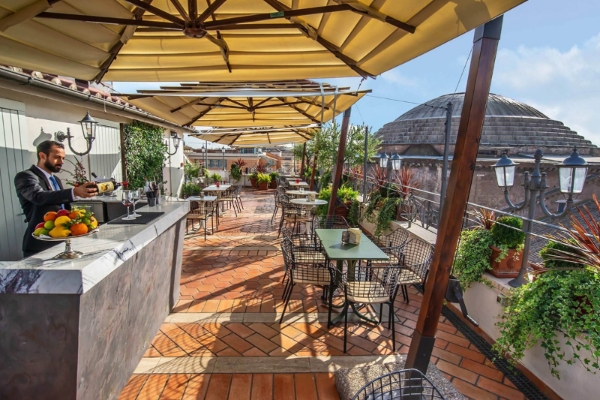 Albergo del Senato - a patio with tables and chairs