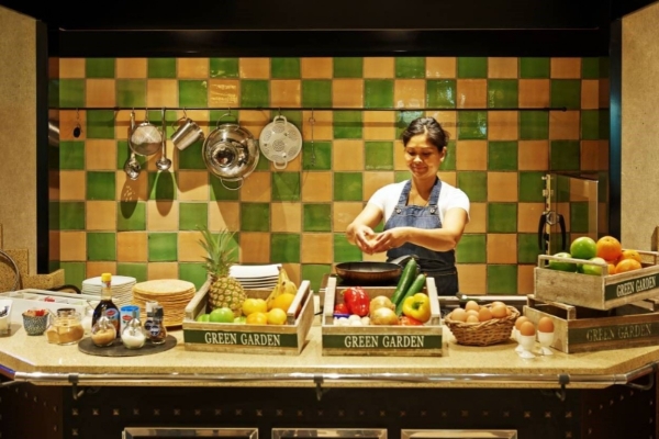 Banks Mansion - a woman cooking in a kitchen