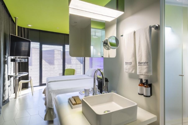 Barcelo Raval - a bathroom with a sink and a mirror