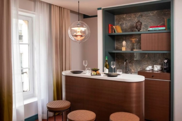 Bel Ami Hotel - a bar with wine glasses and a shelf in a room